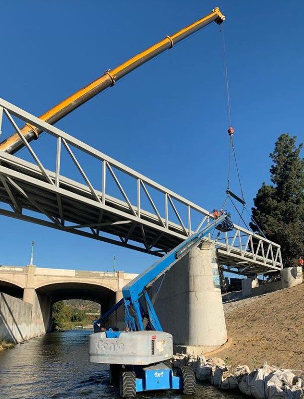 Crane hoisting Red Car bridge section into place